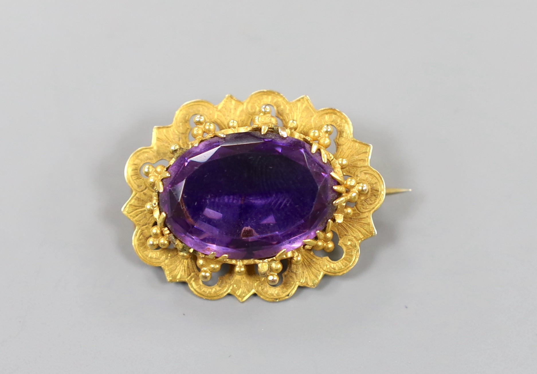 A yellow metal and foil backed amethyst? set oval brooch, 29mm, gross weight 7.5 grams.